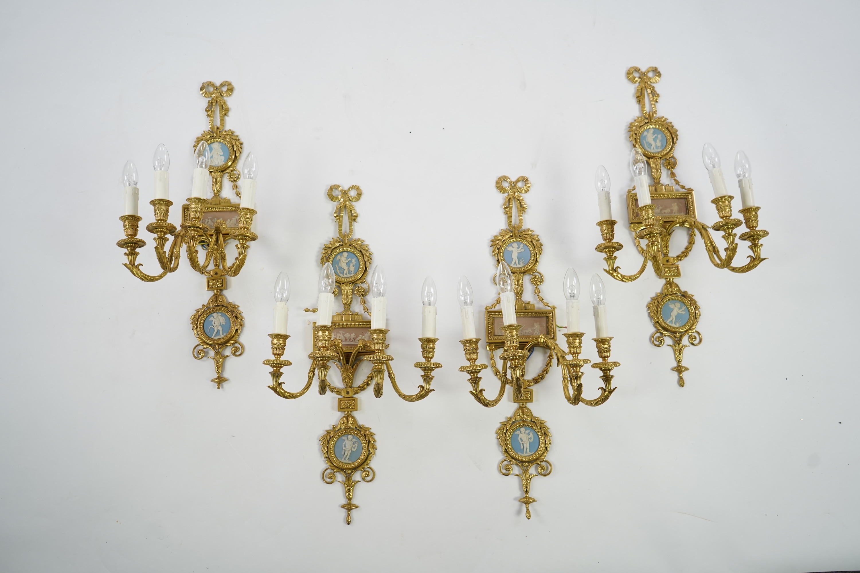 A set of four Adam style ormolu and jasper ware mounted wall appliques, early 20th century